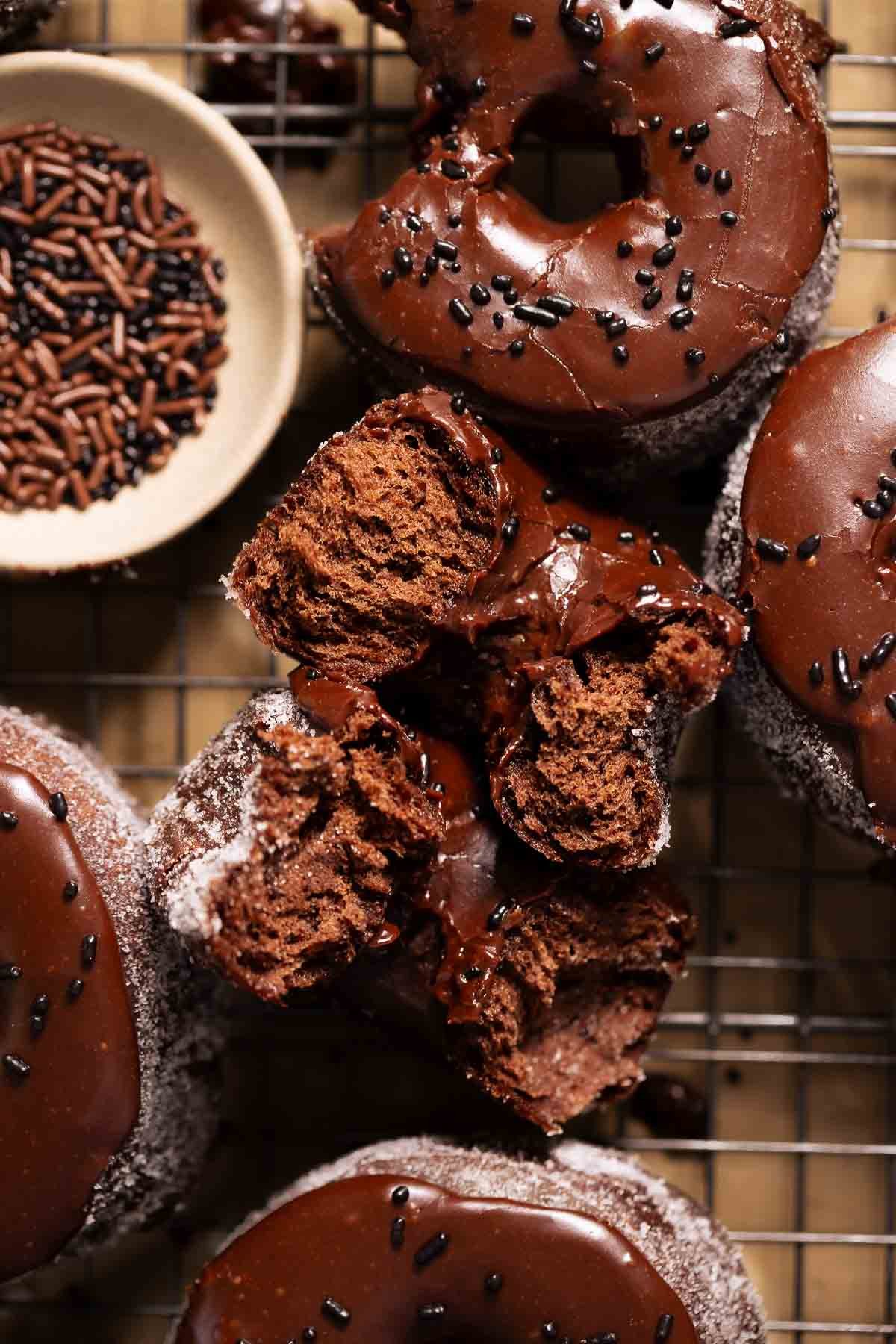 A chocolate doughnut broken in half to show the soft and fluffy texture.