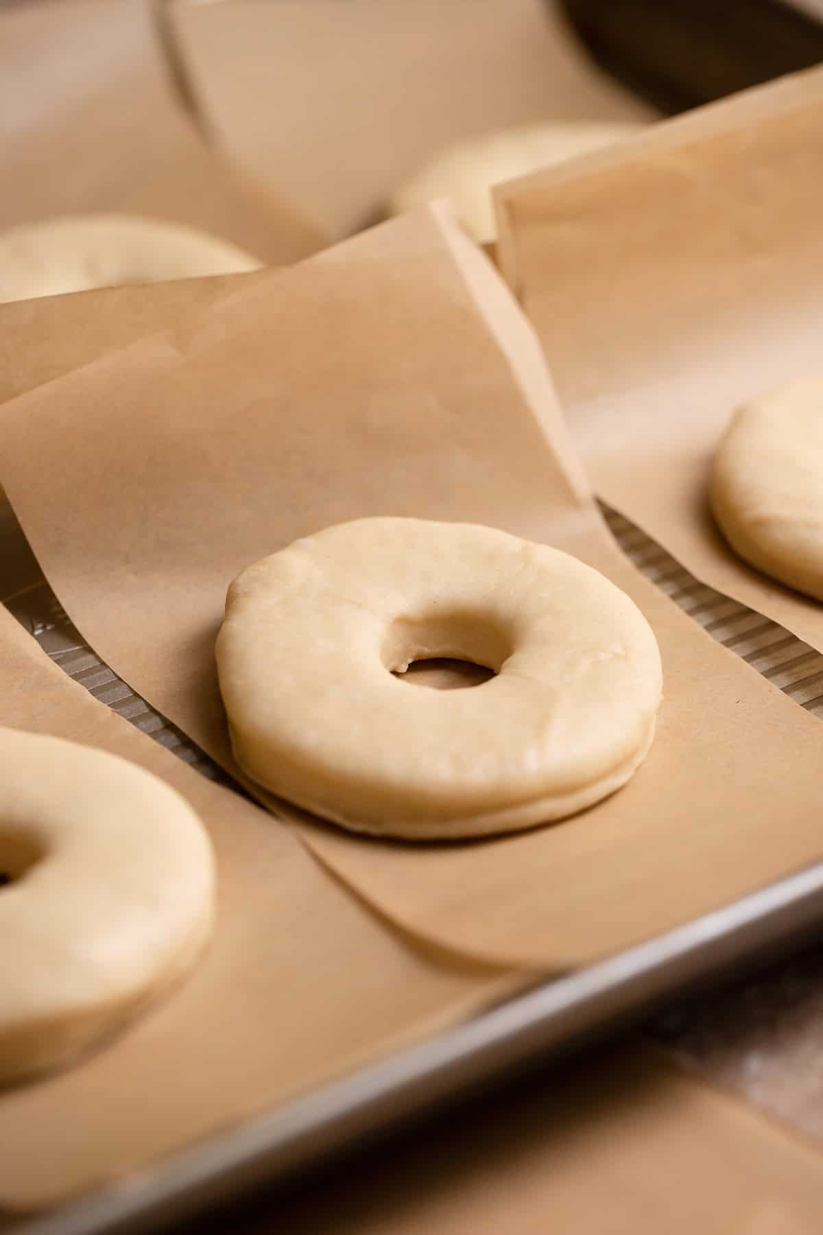 Cut out donuts on individual squares of parchment paper.