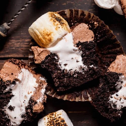 Hot chocolate cupcakes cut in half to show the marshmallow filling.