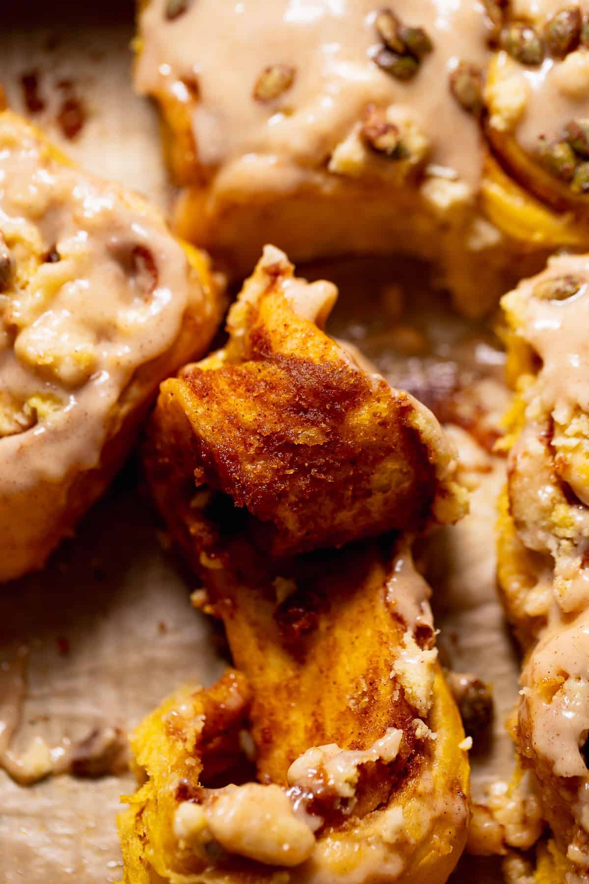 A pumpkin pie roll half unrolled in a baking pan to show the gooey filling.