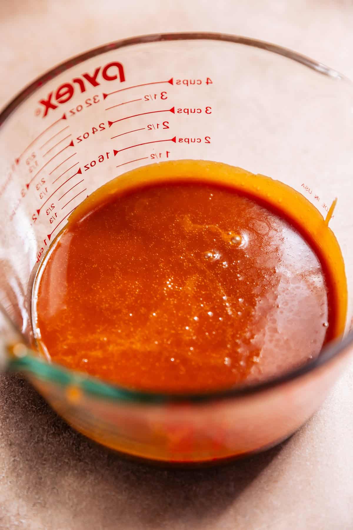 A glass mixing bowl of salted caramel.