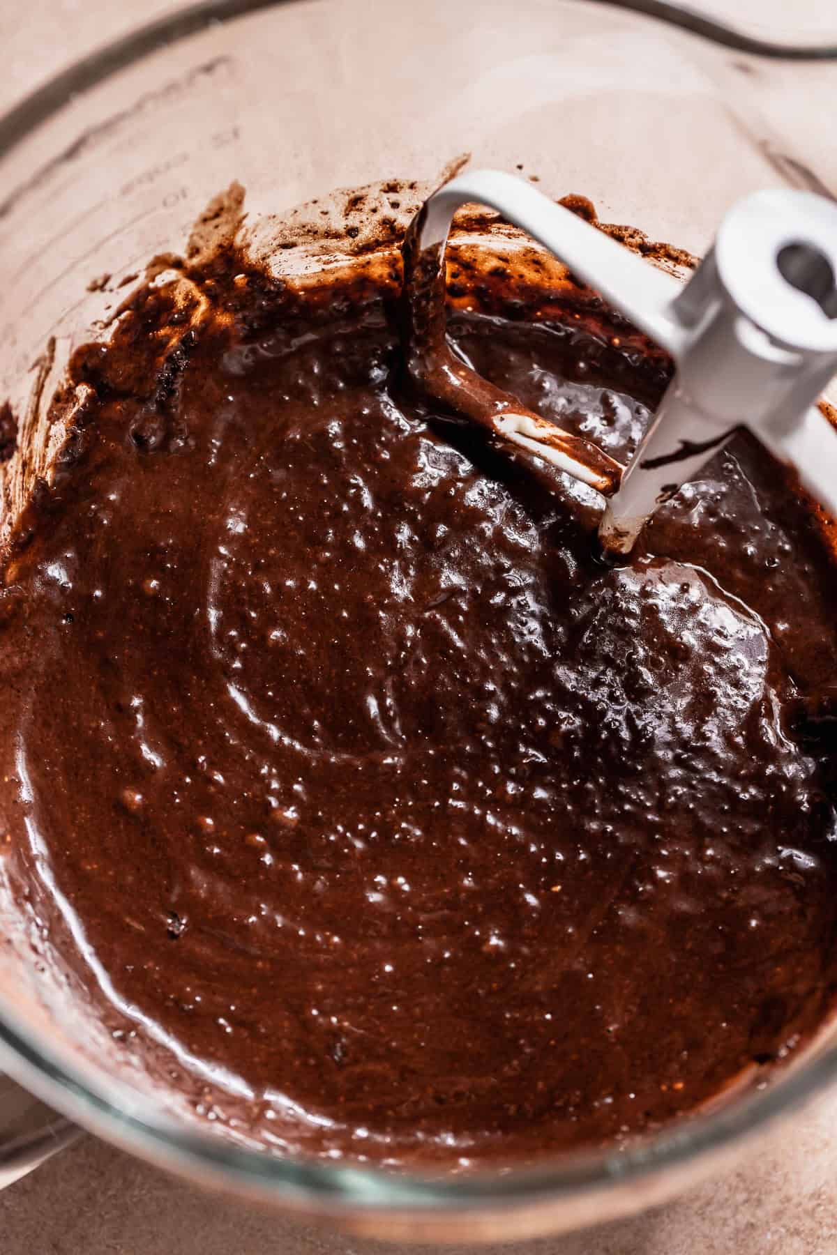 Chocolate cupcake batter in a stand mixer bowl.