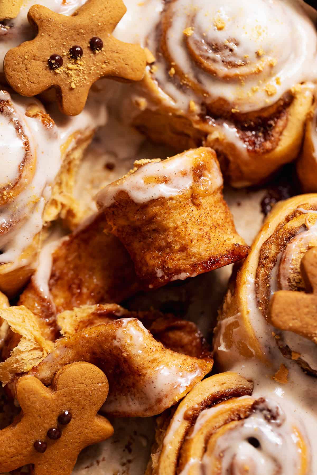 A gingerbread bun half unrolled in a baking pan.