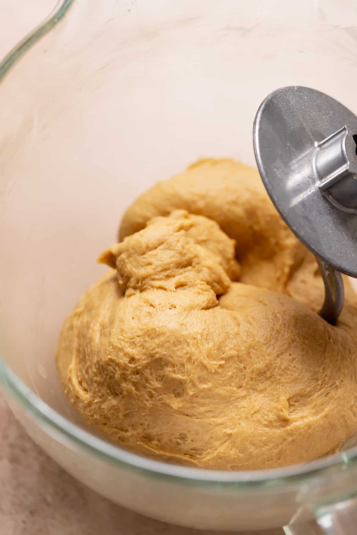 Molasses yeast dough for gingerbread rolls in a stand mixer bowl.