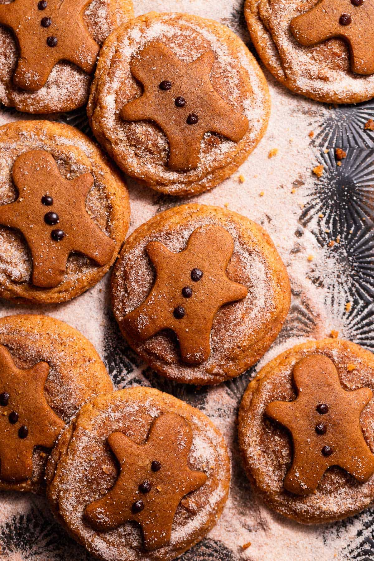 Freshly baked gingerdoodle cookies on a cookie sheet coated in gingerbread spiced sugar.