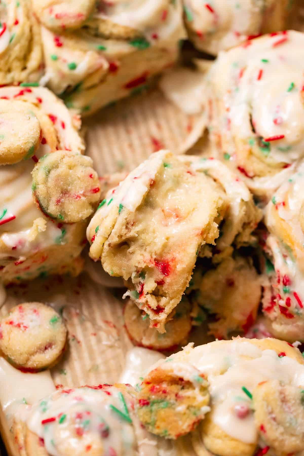 Close-up of a Christmas sugar cookie roll with gooey sugar cookie filling and colorful holiday sprinkles.