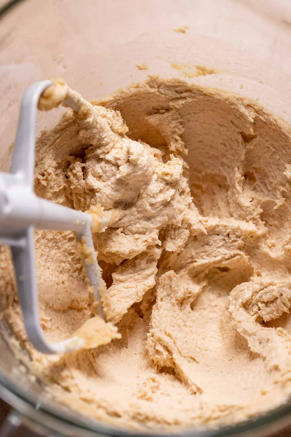 Smooth creamed butter and sugar mixture in a stand mixer bowl with a paddle attachment.