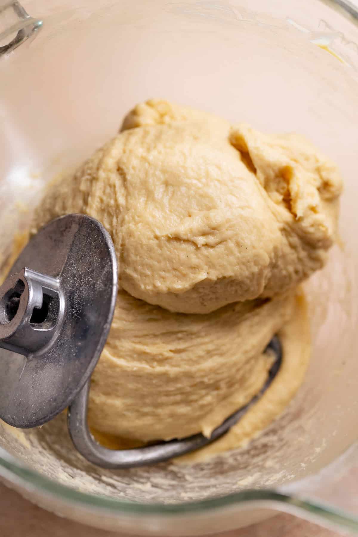 Soft banana yeast dough kneaded in a stand mixer with a dough hook.
