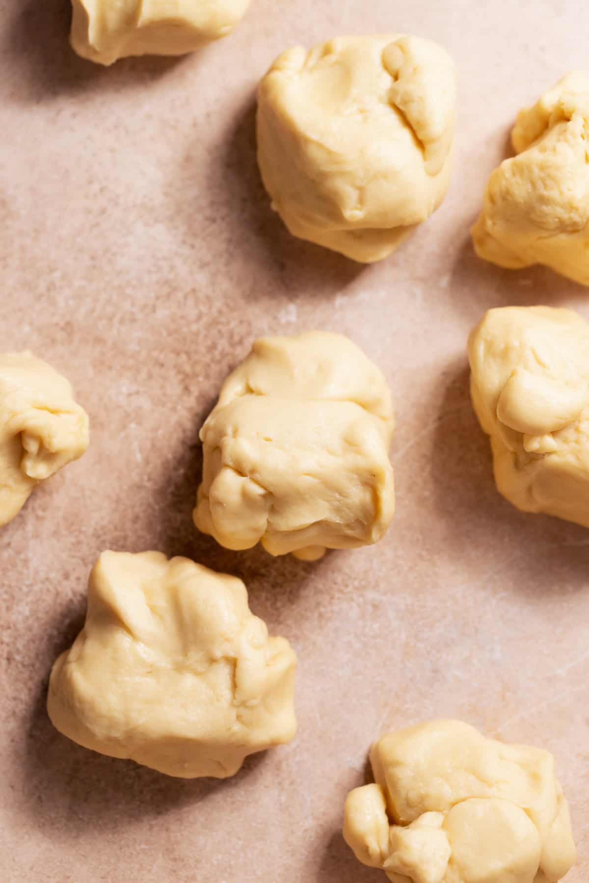 Portioned pieces of enriched dough on the counter ready for shaping.