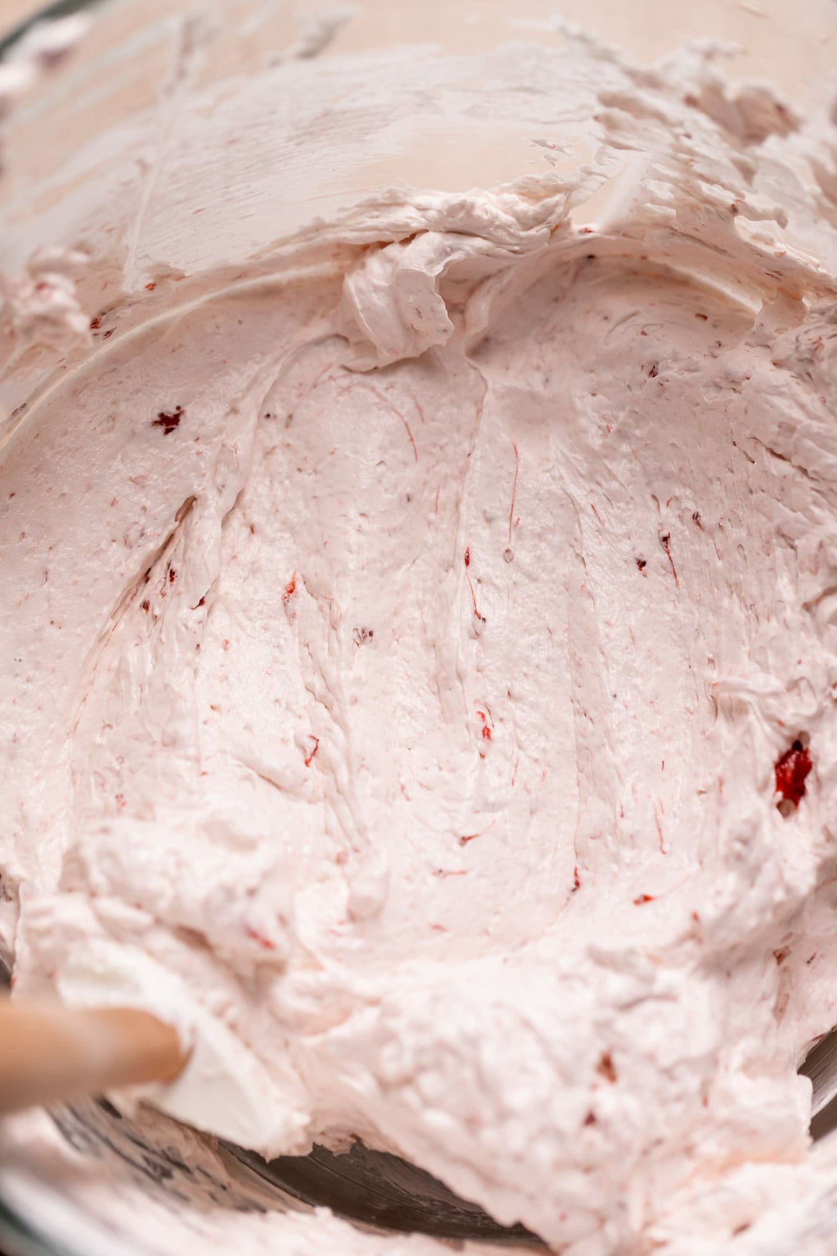 Strawberry Swiss meringue buttercream in a mixing bowl.