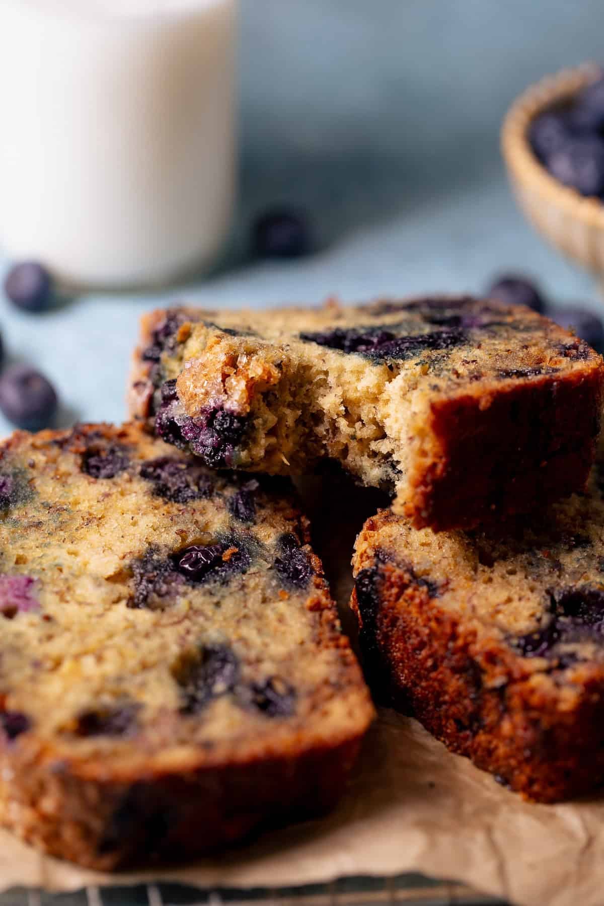 Close-up of a slice of blueberry banana bread showing a moist, tender crumb.