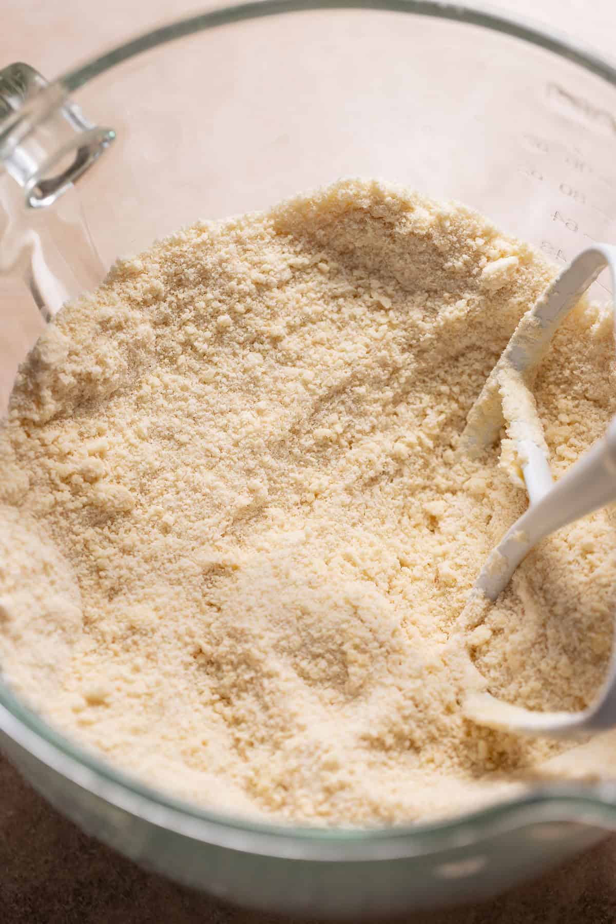 Bowl of flour and butter mixture with a crumbly texture for cake batter.