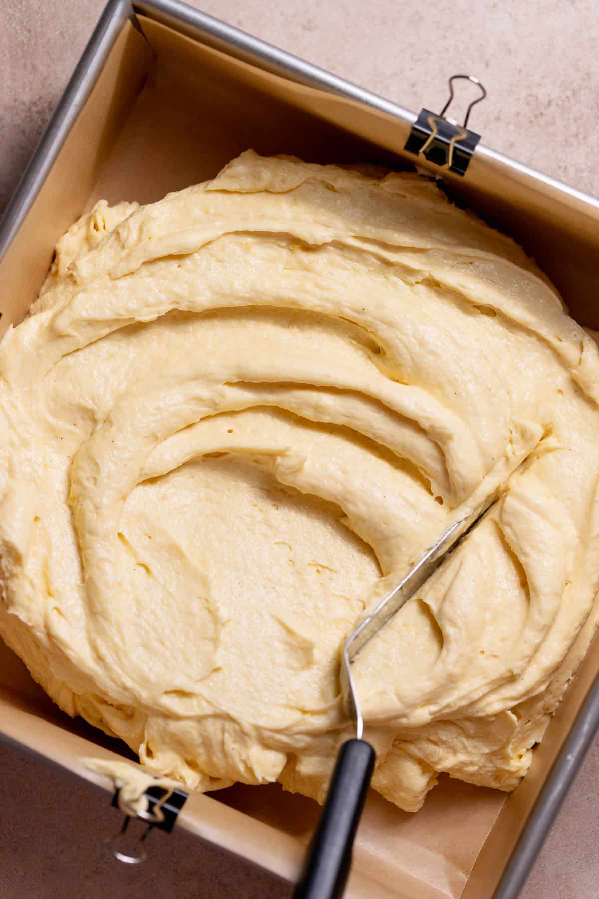 Vanilla cake batter spread in a pan.