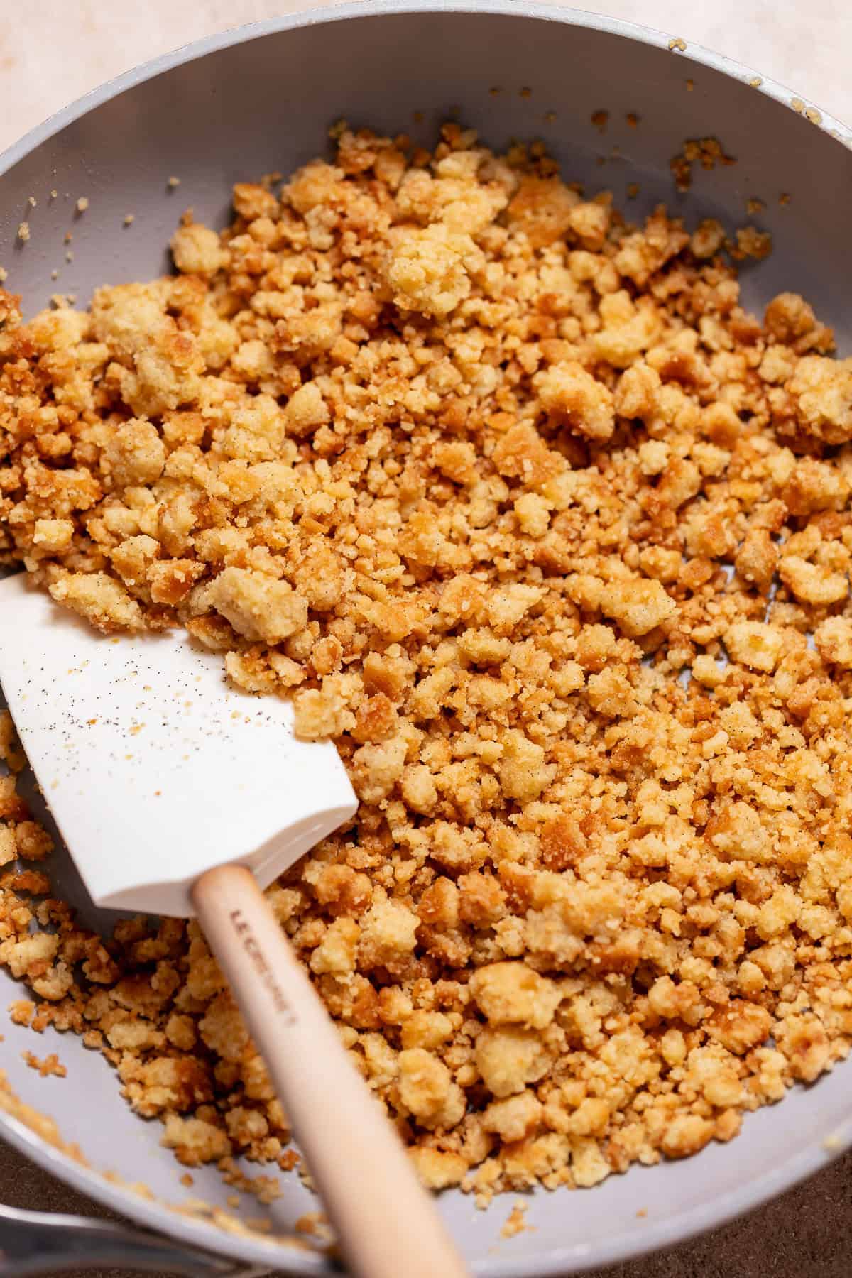 Buttery cobbler crumble topping cooked in a skillet with golden brown crisp crumbs.