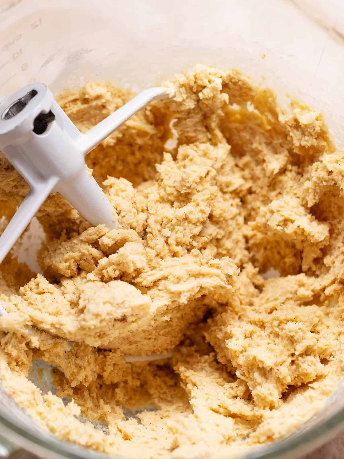 Vanilla shortbread dough mixed in a stand mixer bowl.