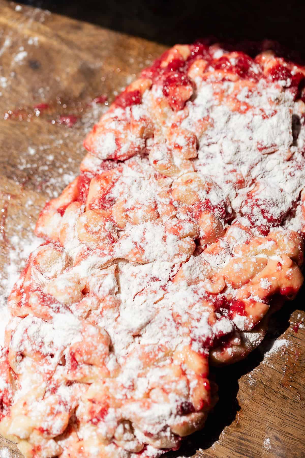 The fritter dough pieces shaped back into a log and dusted with flour.