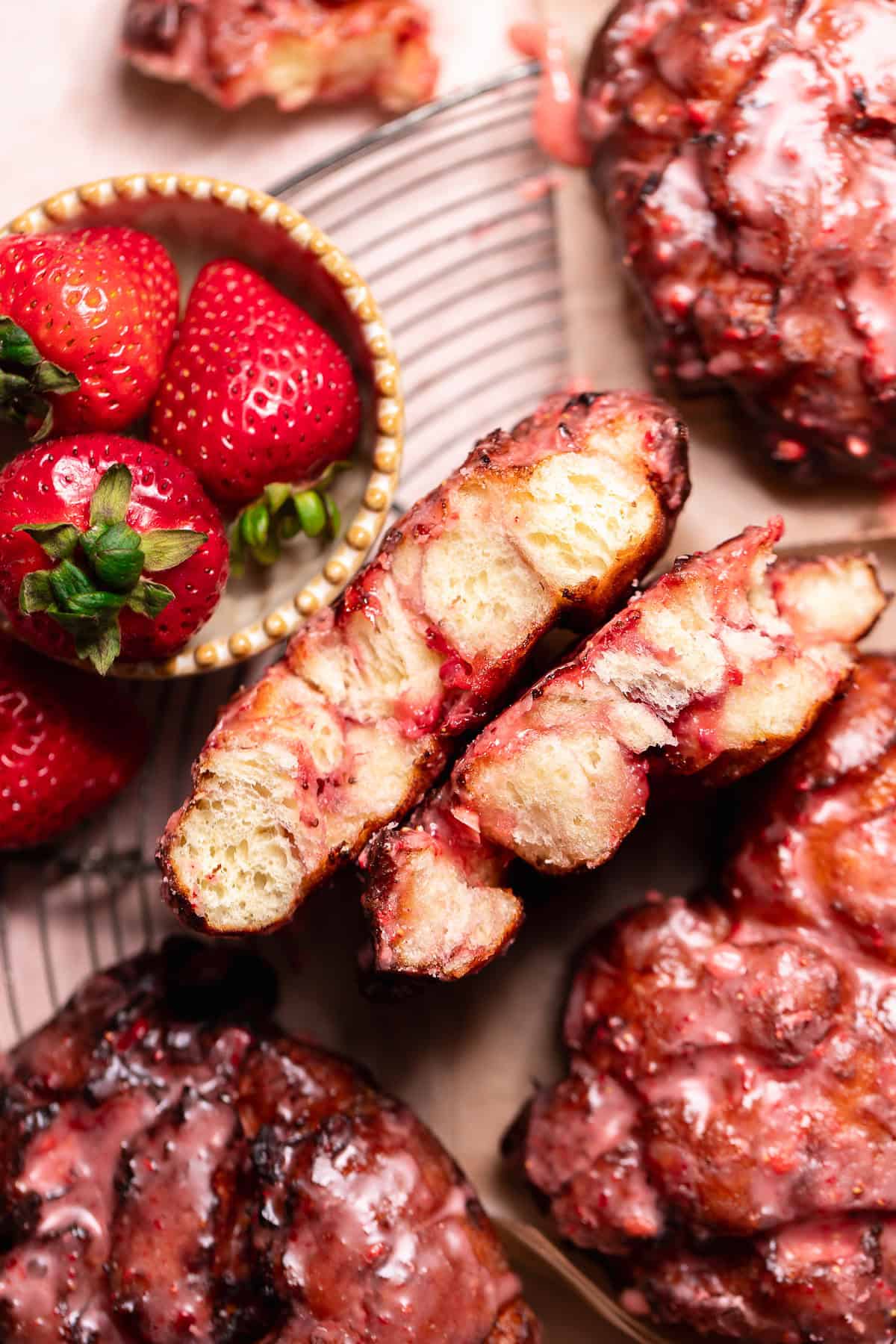 Strawberry fritter broken open to show the soft interior and strawberry filling.