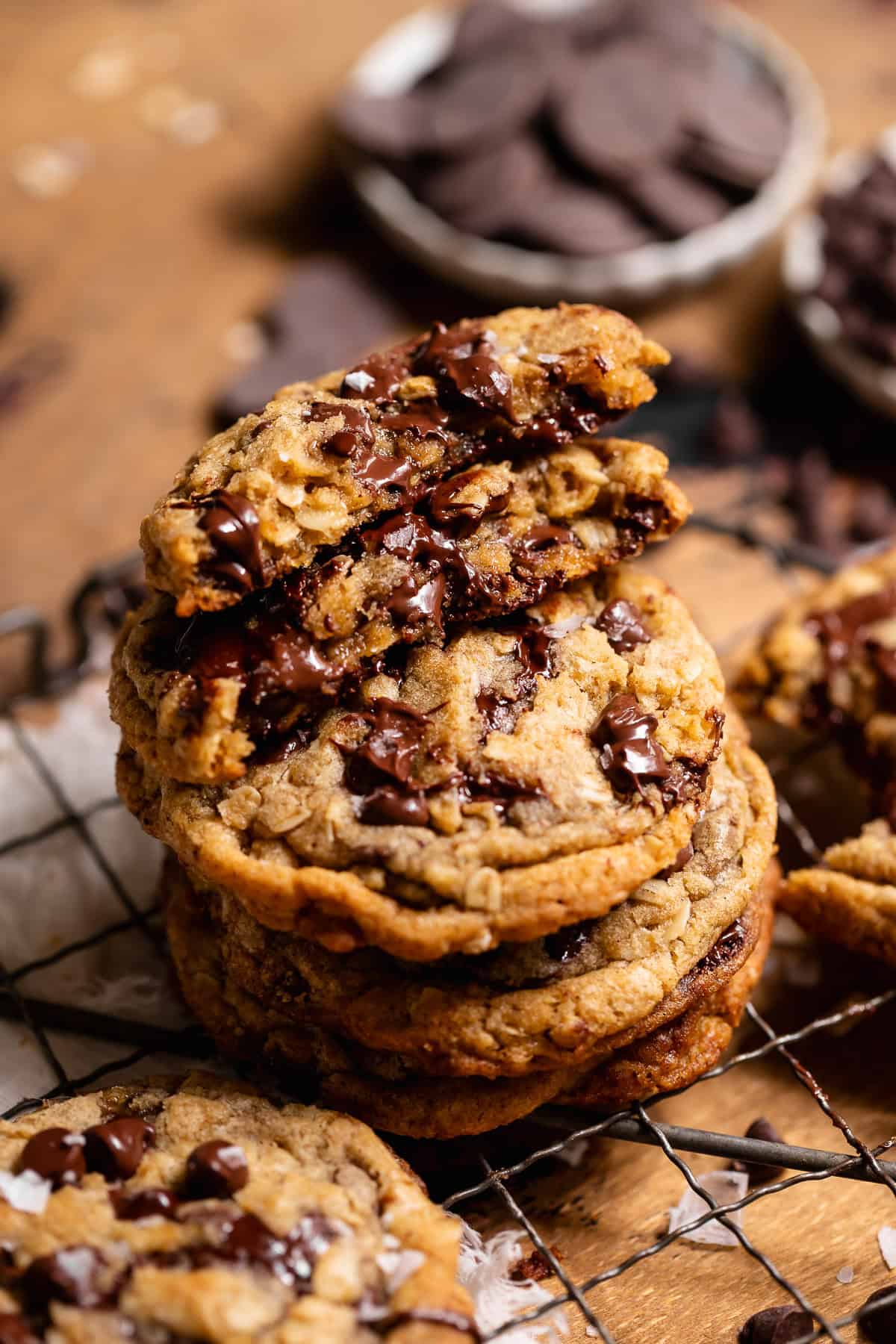 Stack of oatmeal chocolate chip cookies with a broken cookie showing a gooey chocolate center.