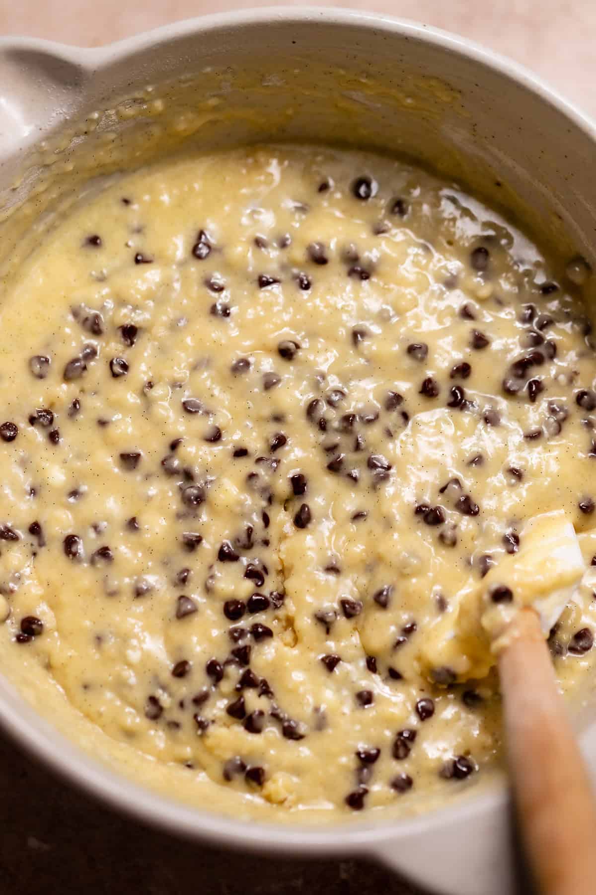 Muffin batter mixed with mini chocolate chips folded in before filling the muffin liners.