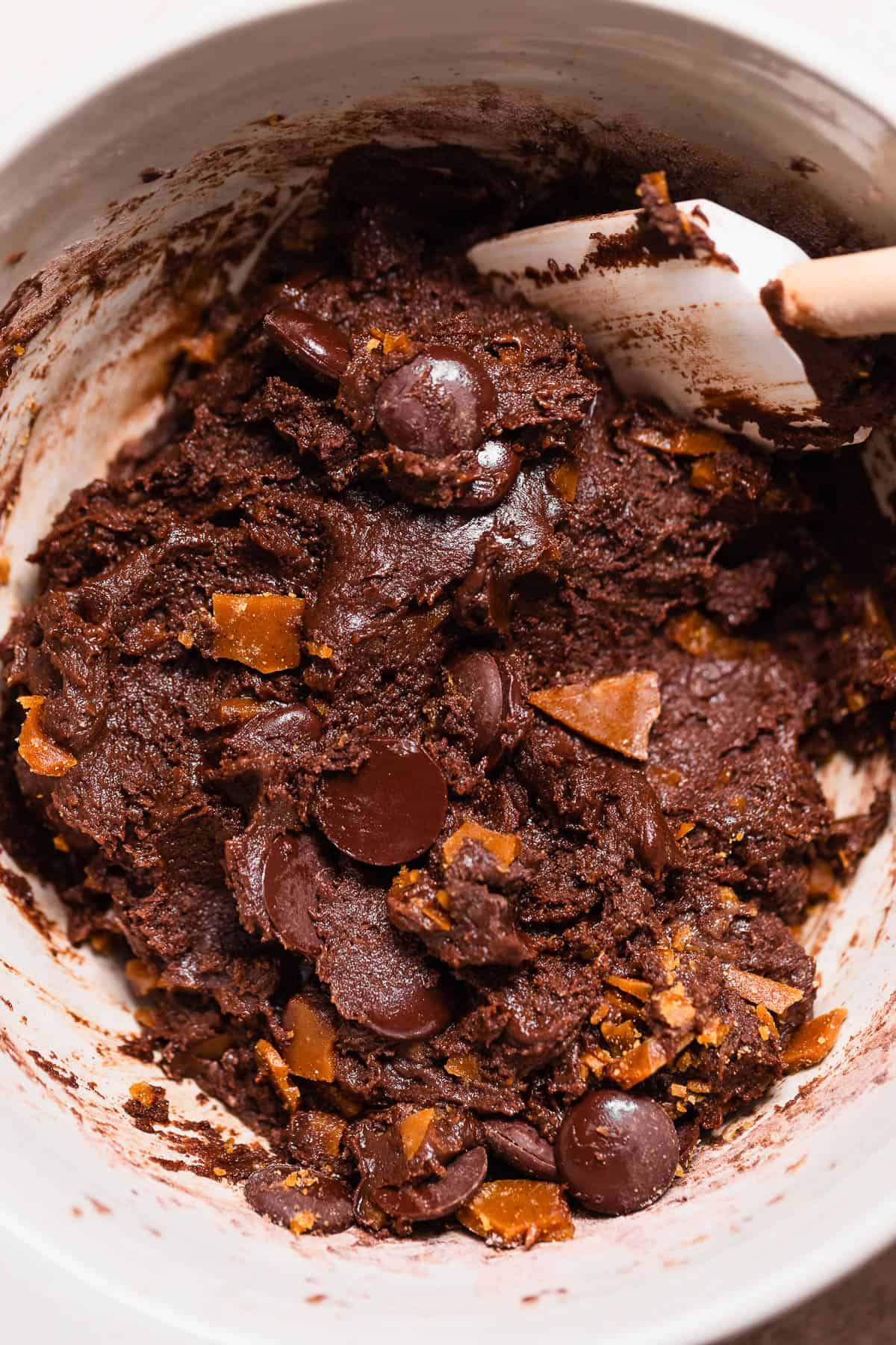 Double chocolate cookie dough folded with homemade toffee pieces and dark chocolate wafers before chilling.