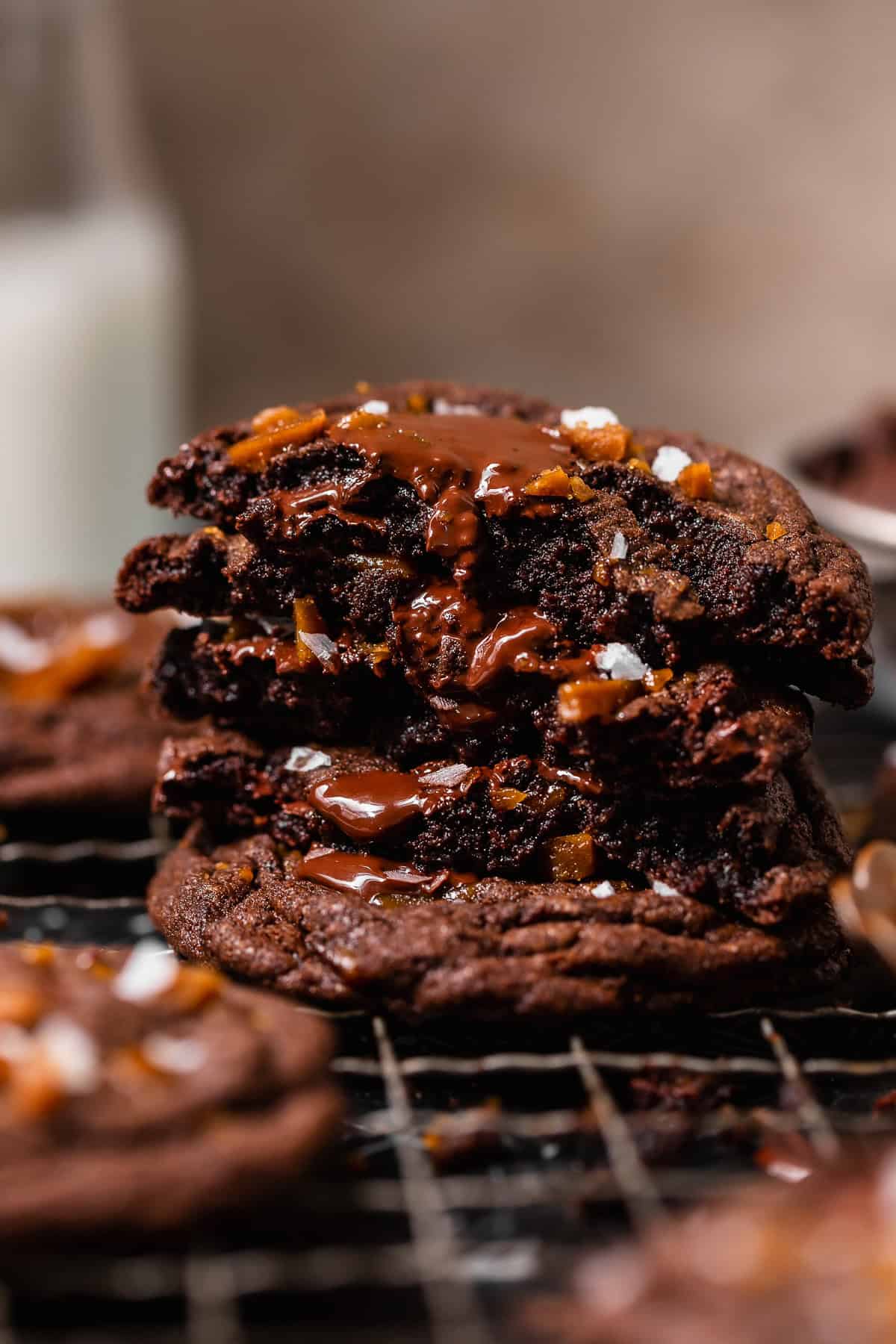Stack of chocolate toffee cookies with gooey melted chocolate and crunchy toffee pieces inside.