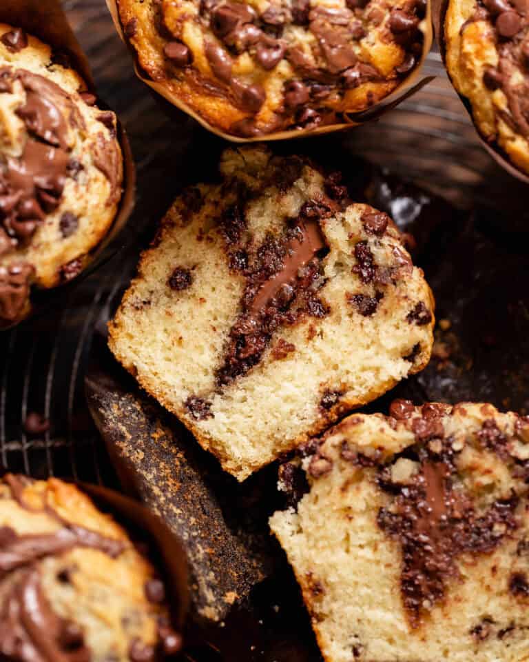 Chocolate Nutella muffin cut in half to reveal the melted Nutella center and soft crumb.