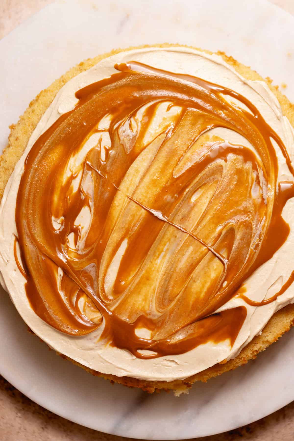Cake layer spread with cookie butter frosting and swirled Biscoff spread.