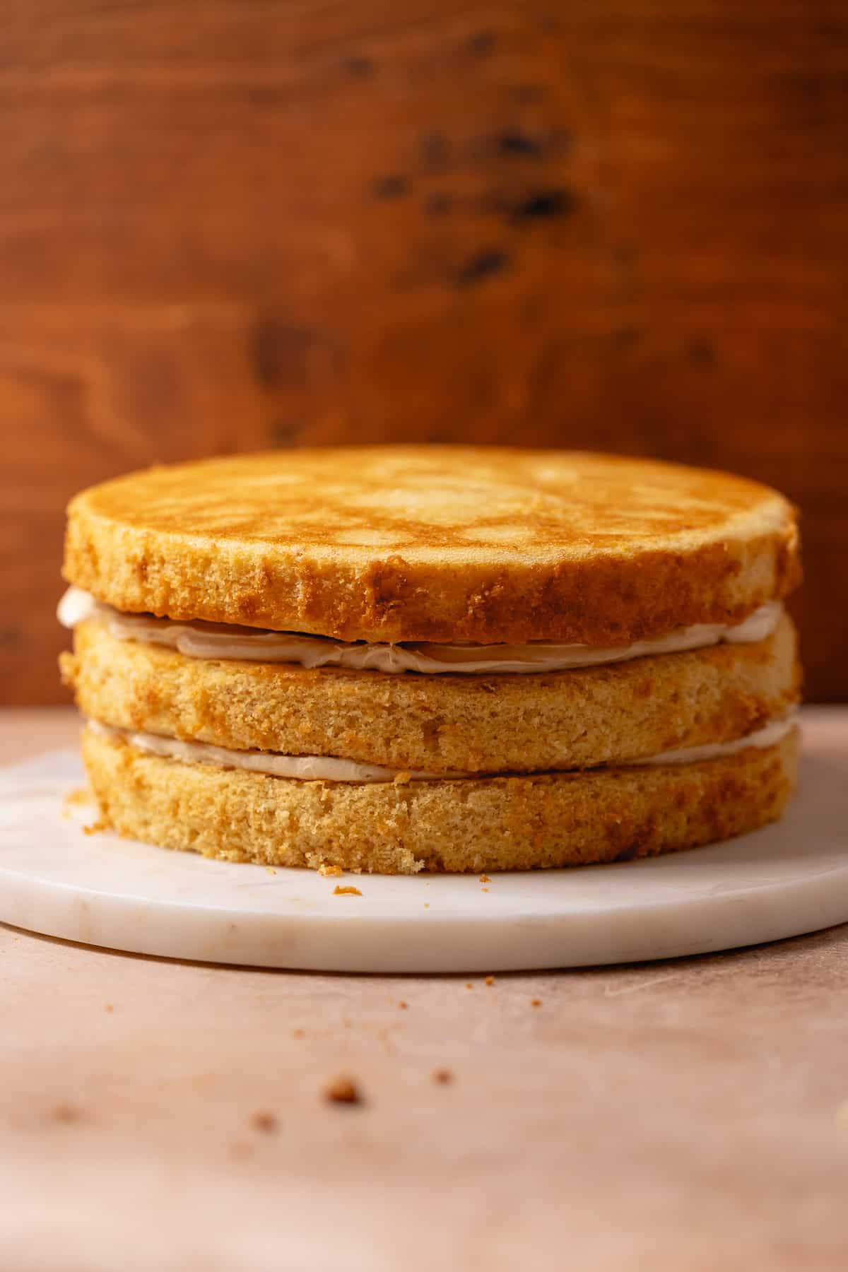 Three round cake layers stacked with a thin layer of frosting between each layer.