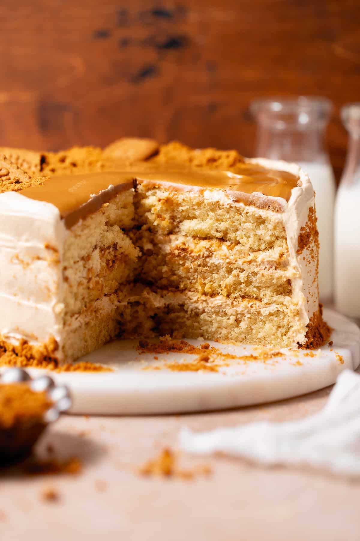 Close-up of a sliced Biscoff cake showing the soft crumb and cookie butter filling between three layers.