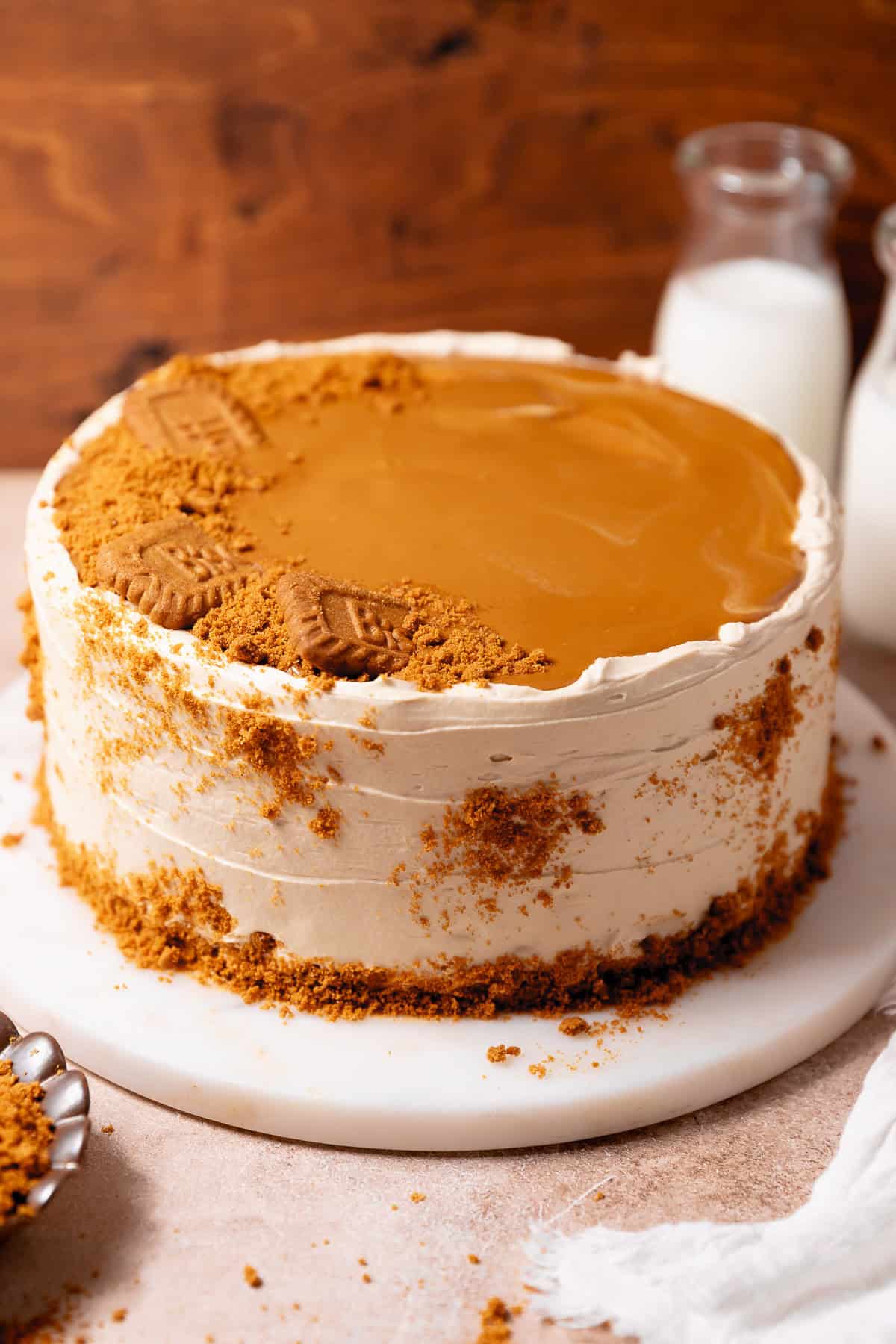 Three-layer Biscoff cake frosted with cookie butter buttercream and topped with Biscoff spread and cookie crumbs.
