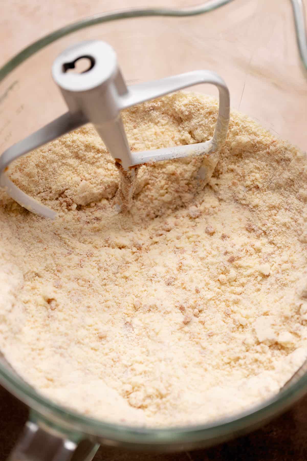 Crumbly flour and butter mixture in a stand mixer bowl after reverse creaming.