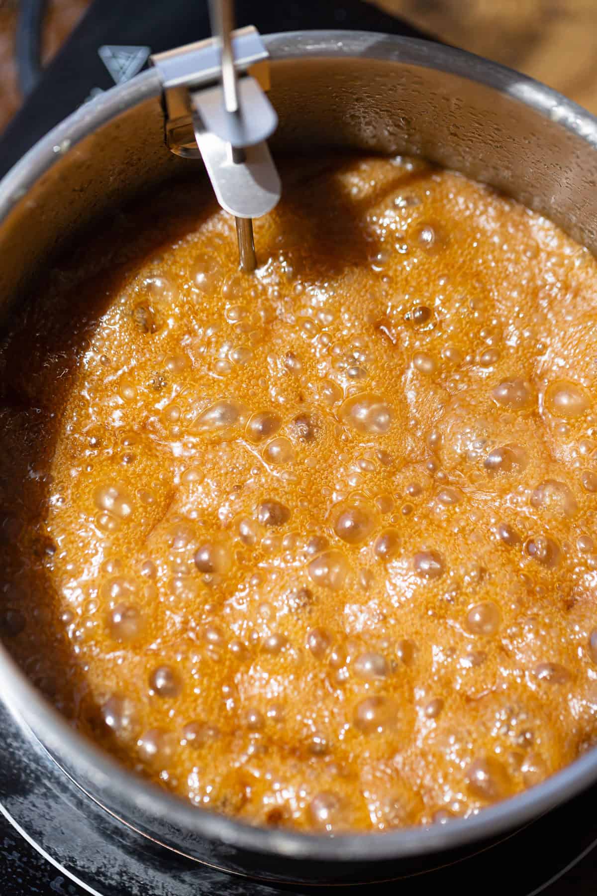 Butter pecan caramel sauce bubbling in a saucepan while cooking.